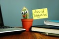 Avoid negative. Smiling cactus on the desk. Positive thinking
