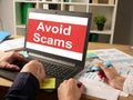 Avoid Scams is shown on the conceptual business photo