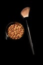 Avon glow bronzing pearls isolated on dark background. Royalty Free Stock Photo