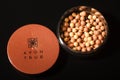 Avon glow bronzing pearls isolated on dark background.