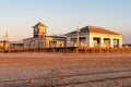 Golden hour sunrise on the beach pavilion and boardwalk from the beach Royalty Free Stock Photo