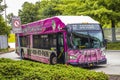 A pink Marta bus with advertisements