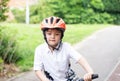 Avtive kid wearing a bike helmet, Outdoors portrait Happy kid with smiling face wearing a cycling helmet riding a bicycle in the Royalty Free Stock Photo