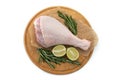 Aw leg of turkey cutting board with limes and parsley on a white background, isolate Royalty Free Stock Photo