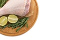 Aw leg of turkey cutting board with limes and parsley on a white background, isolate Royalty Free Stock Photo