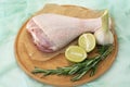Aw leg of turkey cutting board with limes and parsley on a white background, isolate Royalty Free Stock Photo