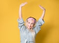 Awakening in good mood. Young woman waking up,wearing sleep mask and stretching arms up, isolated on white background