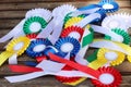 Award rosettes for winner in various colors. Colorful ribbons badges for equestrian champions on competition dressage