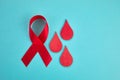 Awareness oncept with blood drop and red ribbon. World Hamophilia day or blood donor day.