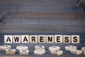 Awareness word written on wood block. Dark wood background with texture Royalty Free Stock Photo