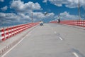 Awasome bridge in river. Flying plane in sky on narsingdi, bangladesh