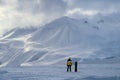 Away snowboarder stands and looks at mountains