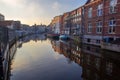 Awe landscape with moored boats at the edge of the canal. in Amsterdam in winter