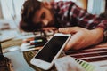 Aweary Tired Guy Lying on Table with Smartphone