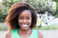 Awesome african american woman in a green shirt outdoor