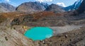 Awesome alpine panoramic view from pass to mountain valley in sunlight and great mountain silhouettes on horizon. Colorful green Royalty Free Stock Photo