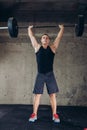 Awesome athlete raises the barbell over his head. Royalty Free Stock Photo