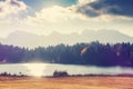 Awesome autumn landscape at mountains valley with lake and sky. View over Geroldsee with wooden hut and Karwendel mountains at Royalty Free Stock Photo