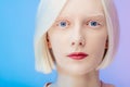 Awesome beautiful albino with makeup and blue eyes looking at the camera