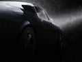 Awesome black vintage muscle car in the rain