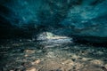 Awesome blue ice cave carved into the Vallelunga glacier crossed by a stream Royalty Free Stock Photo