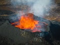 Close up view of boiling lava lake inside volcano crater, drone top down shot