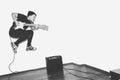 Awesome crazy fashion young musician rock guitar player jumps with passion in studio. Stylish rocky emotional man. Black Royalty Free Stock Photo
