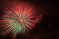 Awesome green and red fireworks fountains above trees and a illuminated church Royalty Free Stock Photo
