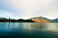 Awesome nature scenery of mountain Cecil Peak and autumn forest above Lake Wakatipu