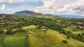 Awesome panoramic aerial view above italy countryside with oak forests and green valley with pathways , rural settlements between Royalty Free Stock Photo