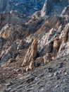 Awesome scenic mountain landscape with big cracked pointed stones closeup in sunlight. Sharp rocks background. Vertical view
