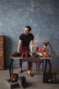 Awesome shoeshine man looking aside while standing at workplace