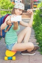 Awesome skateboarder girl making selfie on mobile phone Royalty Free Stock Photo