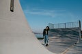 Awesome skateboarder girl with skateboard outdoor at skatepark. Skatebord at city, street. Cool, Funny Tenager. Royalty Free Stock Photo