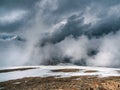 Awesome storm, a snowy atmospheric front in the mountains.Atmospheric alpine view to snow mountain range with low clouds. Scenic Royalty Free Stock Photo