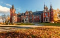 Awesome sunny Landscape, Perfect Sky over the Fairytale castle with Fall Autumn Leafes on foreground. Amazing view on Palace in