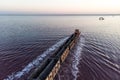 Awesome train rides on rail in the water with white salt on the background of beautiful blue sky. aerial view, view from