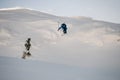 awesome view of male skier making jump while sliding down snow-covered slope on skis Royalty Free Stock Photo