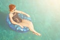 Woman relax on inflatable ring in sea water