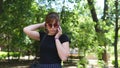 Awesome young woman in sunglasses talking on phone in park