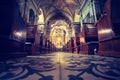 Historic catholic church: Wooden pews in a row and altar width crucifix