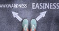 Awkwardness and easiness as different choices in life - pictured as words Awkwardness, easiness on a road to symbolize making Royalty Free Stock Photo