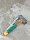 Awl and hammer on concrete flooring