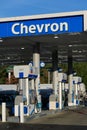 Awning sign and pumps at Chevron gas station in daytime