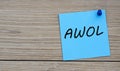 AWOL - acronym written on a blue sheet pinned to a wooden board Royalty Free Stock Photo