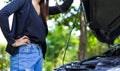 Awoman with a broken car and she open bonnet. Royalty Free Stock Photo