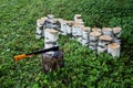 The ax of the cleaver stuck into the log, stands on the green grass Royalty Free Stock Photo