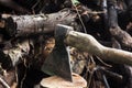 An ax in a hemp on logs background Royalty Free Stock Photo