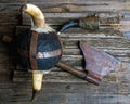 Ax horned helmet and viking signal horn on rough wooden table top view
