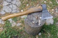 an ax with a wooden handle lies on a wooden block Royalty Free Stock Photo